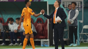 Netherlands coach Louis Van Gaal greets forward Cody Gakpo as he leaves the pitch during their Round of 16 match against USA: AFP/Adrian Dennis