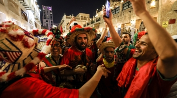 Moroccon fans celebrate their team's qualification for the next round after their victory over Canada, at the Souq Waqif: AFP/Mahmud Hams