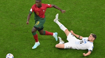 Portugal’s Nuno Mendes gets the ball past Uruguay’s Federico Valverde: AFP/Glyn Kirk