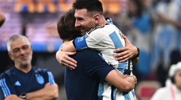 Lionel Messi celebrates with coach Lionel Scaloni  after Argentina won the Qatar 2022 World Cup final match against France at Lusail Stadium in Lusail, north of Doha on December 18, 2022. (Photo by Anne-Christine POUJOULAT / AFP)