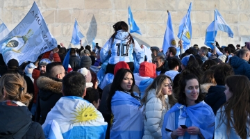 Fans wave Argentine flags as they celebrate their team's victory in the Qatar 2022 World Cup final football match against France, in Washington, DC, on December 18, 2022. (Photo by Daniel SLIM / AFP)
