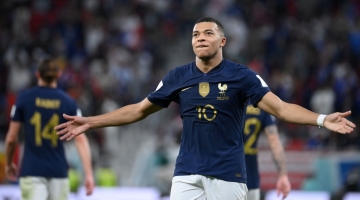 France's forward Kylian Mbappe celebrates scoring his team's third goal during the Qatar 2022 World Cup round of 16 match against Poland at the Al-Thumama Stadium in Doha on December 4, 2022. (Photo by FRANCK FIFE / AFP)