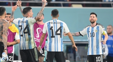 Argentina's forward Lionel Messi (right) celebrate with teammates after they won the Qatar 2022 World Cup round of 16 match against Australia at the Ahmad Bin Ali Stadium in Al-Rayyan on December 3, 2022. (Photo by FRANCK FIFE / AFP)