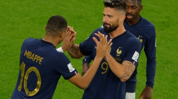 France's Kylian Mbappe (left) celebrates with Olivier Giroud after scoring his team's second goal during the Qatar 2022 round of 16 match against Poland at the Al-Thumama Stadium in Doha on December 4, 2022. (Photo by Odd ANDERSEN / AFP)
