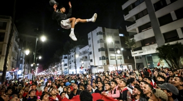 Morocco's supporters celebrate after their country's win of the Qatar 2022 World Cup match between Morocco and Portugal, in the capital Rabat, on December 10, 2022. (Photo by FADEL SENNA / AFP)