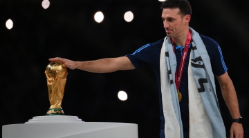 Argentina coach Lionel Scaloni touches the World Cup trophy at the Lusail Stadium on December 18: AFP/Franck Fife
