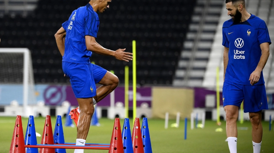 France’s Raphael Varane, left, and Karim Benzema train at the Al Sadd Stadium in Doha on November 17: AFP/Franck Fife