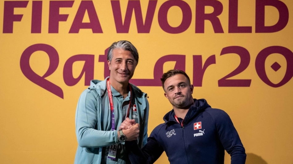 Switzerland's coach Murat Yakin (left) and  Xherdan Shaqiri pose prior to a press conference at the Qatar National Convention Center (QNCC) in Doha on November 27, 2022. (Photo by FABRICE COFFRINI / AFP)