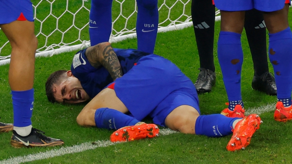 USA's forward Christian Pulisic reacts following a collision during the Qatar 2022 World Cup Group B match against Iran at the Al-Thumama Stadium in Doha on November 29, 2022. (Photo by Odd ANDERSEN / AFP)