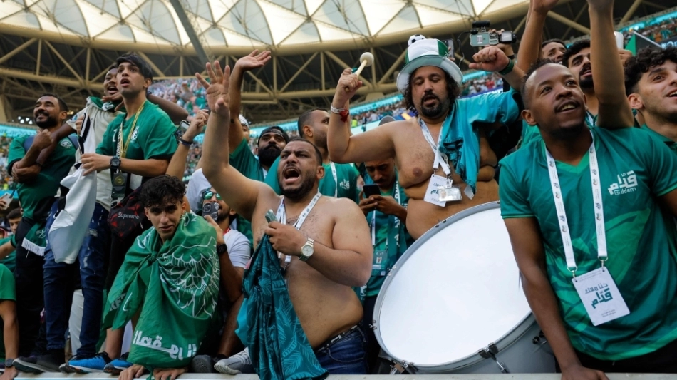 Supporters of Saui Arabia celebrate their team's victory during the Qatar 2022 World Cup Group C football match between Argentina and Saudi Arabia at the Lusail Stadium in Lusail, north of Doha on November 22, 2022. (Photo by Odd ANDERSEN / AFP)