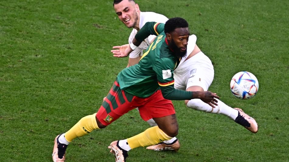 Cameroon’s Georges-Kevin Nkoudoul, left, fights for the ball with Serbia’s Filip Kostic: AFP/Anne-Christine Poujoulat