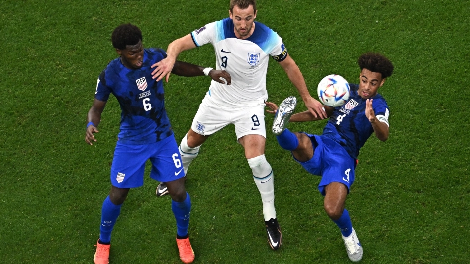 USA’s Yunus Musah, left, Tyler Adams fight for the ball with England’s Harry Kane: AFP/Manan Vatsyayana