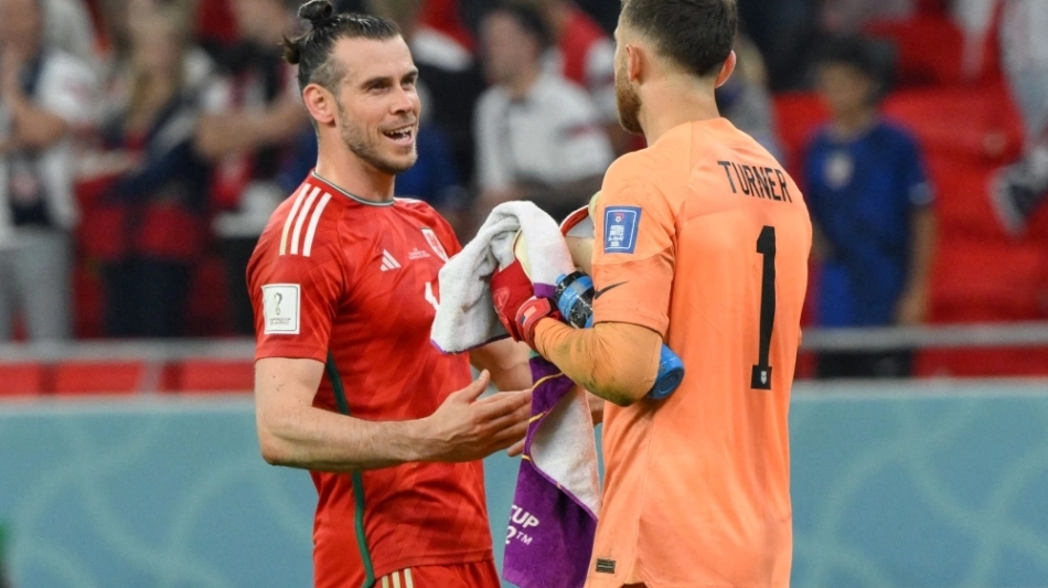Wales' forward Gareth Bale (left) greets USA's goalkeeper Matt Turner at the end of their Qatar 2022 World Cup Group B at the Ahmad Bin Ali Stadium in Al-Rayyan on November 21, 2022. (Photo by NICOLAS TUCAT / AFP)