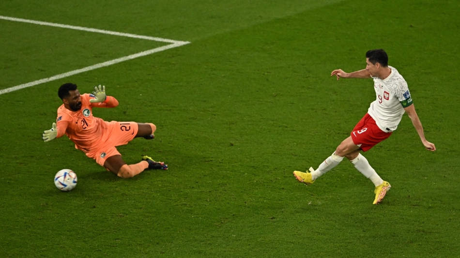 Poland’s Robert Lewandowski scores their second goal past Saudi Arabia’s goalkeeper Mohammed Al Owais: AFP/Manan Vatsyayana