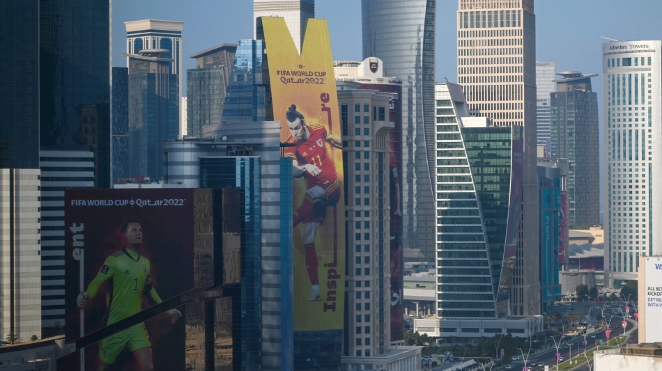 A banner depicting Wales’ captain Gareth Bale (C) hangs alongside a building in Doha on October 23, 2022, ahead of the Qatar 2022 FIFA World Cup football tournament. (Photo by Gabriel BOUYS / AFP).