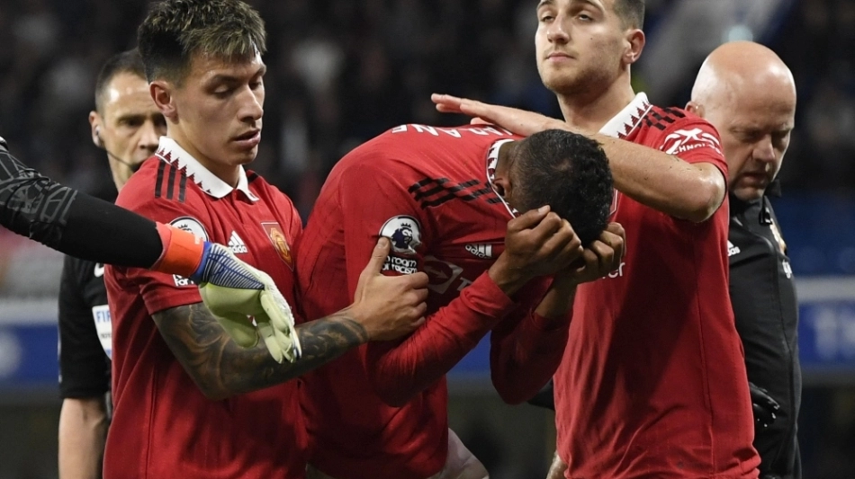 France international and Manchester United defender Raphael Varane in tears after sustaining injury during the Premier League Match against Chelsea at the Stamford Bridge in London on October 22, 2022.