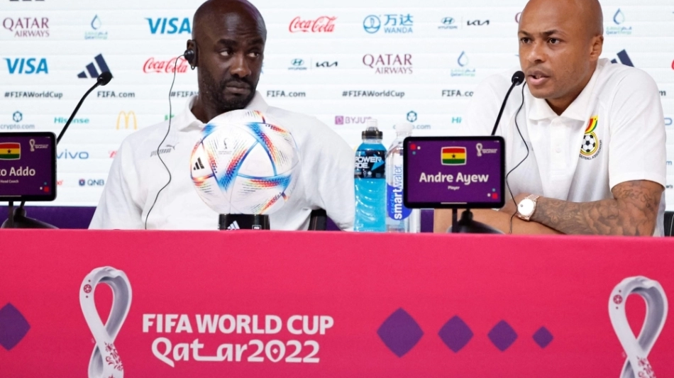 Ghana's coach Otto Addo (left) and midfielder Andre Ayew attend a press conference at the Qatar National Convention Center (QNCC) in Doha on November 23, 2022. (Photo by Khaled DESOUKI / AFP)