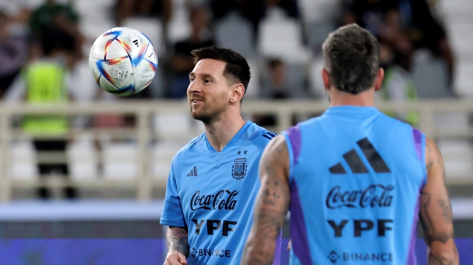 Argentina's forward Lionel Messi (L) controls a ball during a training camp in Abu Dhabi ahead of the Qatar 2022 FIFA football World Cup, at the Nahyan Stadium, on November 14, 2022. (Photo by Karim SAHIB / AFP)