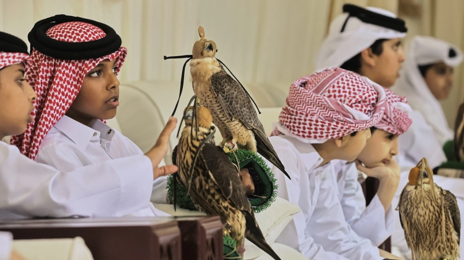 Contestants with their falcons during a junior competition in Ras Laffan, some 80km north of Doha. AFP/Karim Jaafar