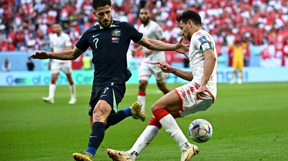 Australia’s Mathew Leckie, left, and Tunisia’s Yousef Msakni battle for possession: AFP/Anne-Christine Poujoulat