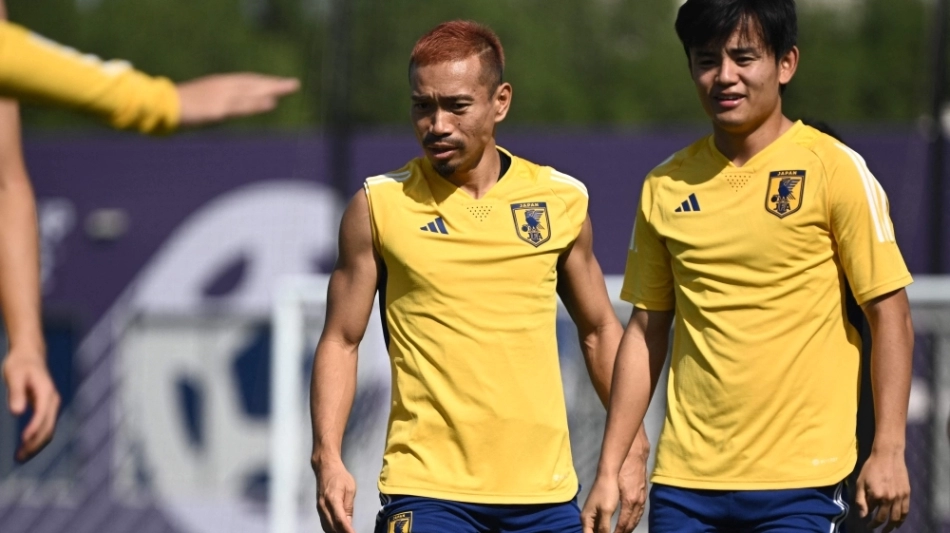 Japan's defender Yuto Nagatomo (left) and midfielder Takefusa Kubo take part in a training session at Al Sadd SC in Doha on November 26, 2022. (Photo by Philip FONG / AFP)