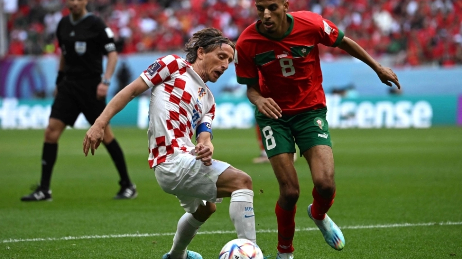 Croatia's Luka Modric and Morocco's Azzedine Ounahi fight for the ball during the World Cup Group F football match at the Al-Bayt Stadium in Al Khor on November 23, 2022. (Photo by OZAN KOSE / AFP)