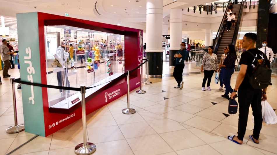 Visitors look at one of the mascots on display at the City Center Mall in Doha.