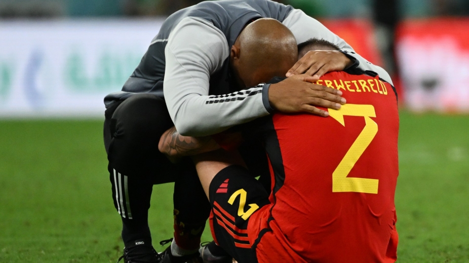 Belgium's assistant coach Thierry Henry hugs defender Toby Alderweireld after the Qatar 2022 World Cup Group F match against Croatia at the Ahmad Bin Ali Stadium in Al-Rayyan on December 1, 2022. (Photo by OZAN KOSE / AFP