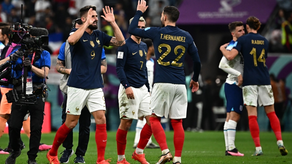 France's Olivier Giroud (left) celebrate with teammates after winning the Qatar 2022 World Cup quarter-final match against France at the Al-Bayt Stadium in Al Khor on December 10, 2022. (Photo by Anne-Christine POUJOULAT / AFP)