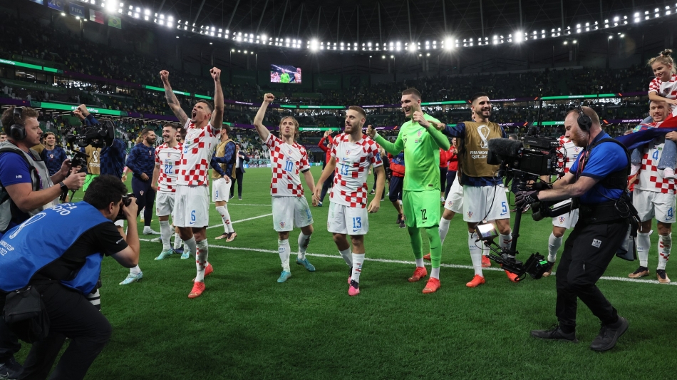 Croatian players celebrate their victory over Brazil: AFP/Jack Guez