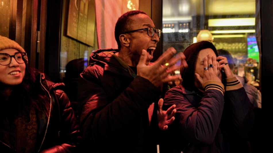 Fans react as they watch the third place football match of the Qatar 2022 World Cup between Croatia and Morocco on a screen at 'Le Galant' bar in central Paris on December 17, 2022. (Photo by Martin LELIEVRE / AFP)