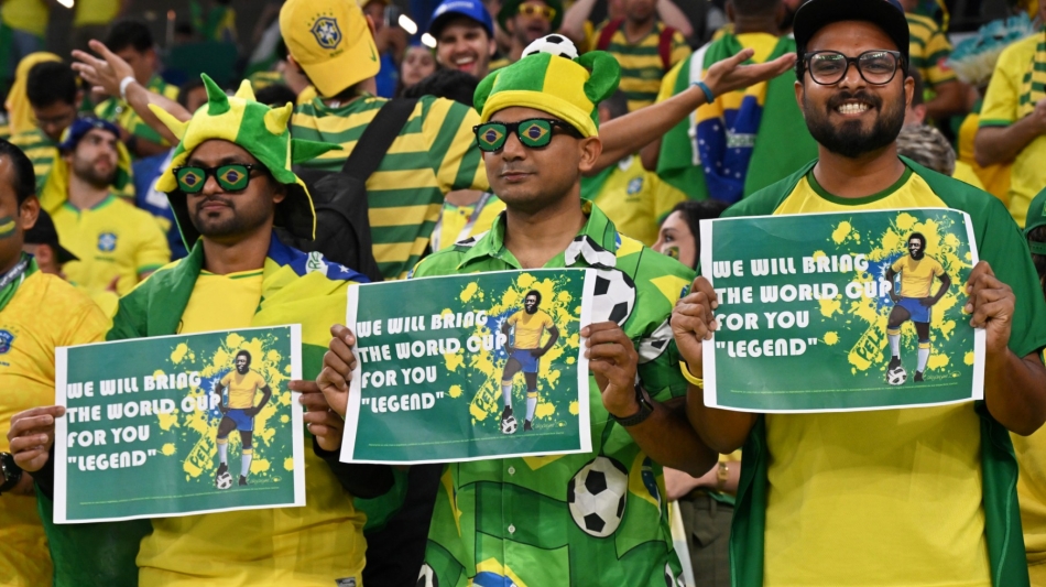Brazil supporters pose with signs for Pele prior to the Qatar 2022 quarter-final match between Croatia and Brazil at Education City Stadium in Al-Rayyan on December 9, 2022. (Photo by NELSON ALMEIDA / AFP)
