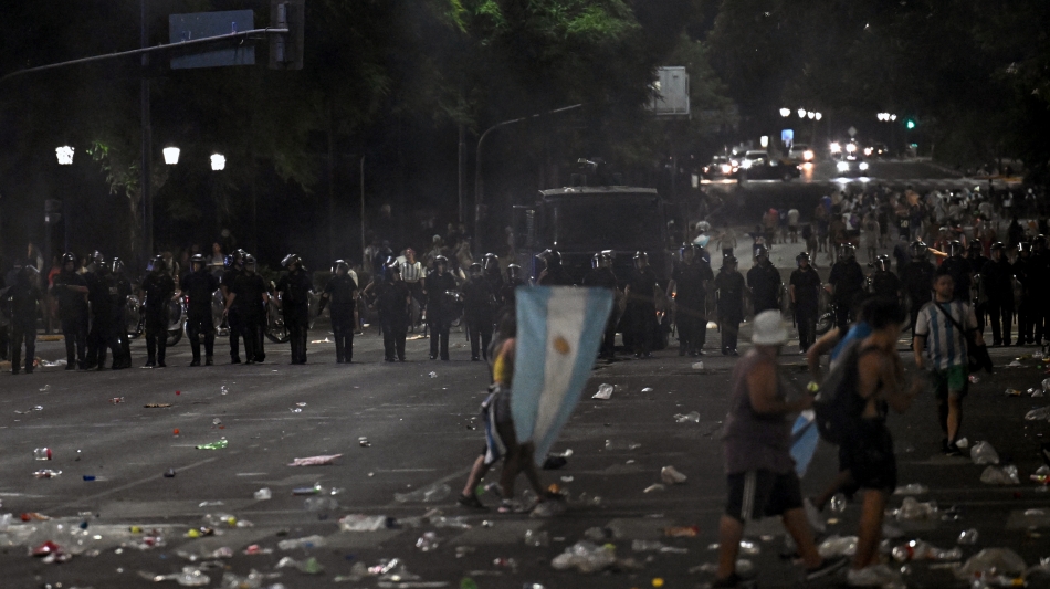 Riot police stand guard after clashes with fans of Argentina following the celebration of the team’s arrival in Buenos Aires: AFP/Luis Robayo