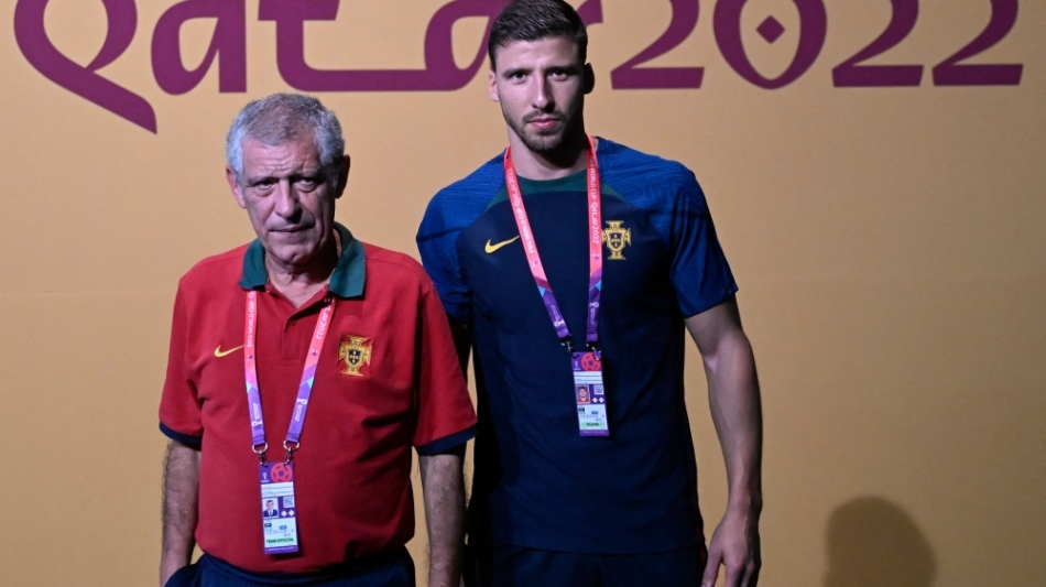 Portugal's coach Fernando Santos (left) and Ruben Dias arrive for a press conference at the Qatar National Convention Center (QNCC) in Doha on December 5, 2022. (Photo by PATRICIA DE MELO MOREIRA / AFP)