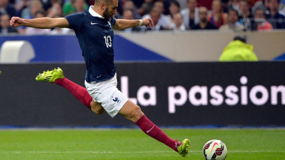 In this file photo taken on September 4, 2014, French forward Karim Benzema strikes during the friendly football match France vs Spain, at the Stade de France in Saint-Denis, north of Paris. (Photo by Miguel MEDINA / AFP)
