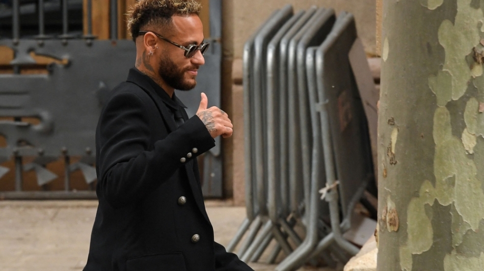 In this file photo taken on October 17, 2022, PSG Brazilian forward Neymar gestures as he leaves leaves after attending the opening audience at the courthouse in Barcelona, on the first day of his trial.  (Photo by Pau BARRENA / AFP)