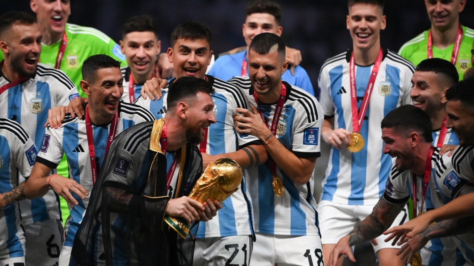 Argentina's Lionel Messi holds the World Cup trophy during the Qatar 2022 World Cup trophy ceremony at Lusail Stadium in Lusail on December 18, 2022. (Photo by FRANCK FIFE / AFP)