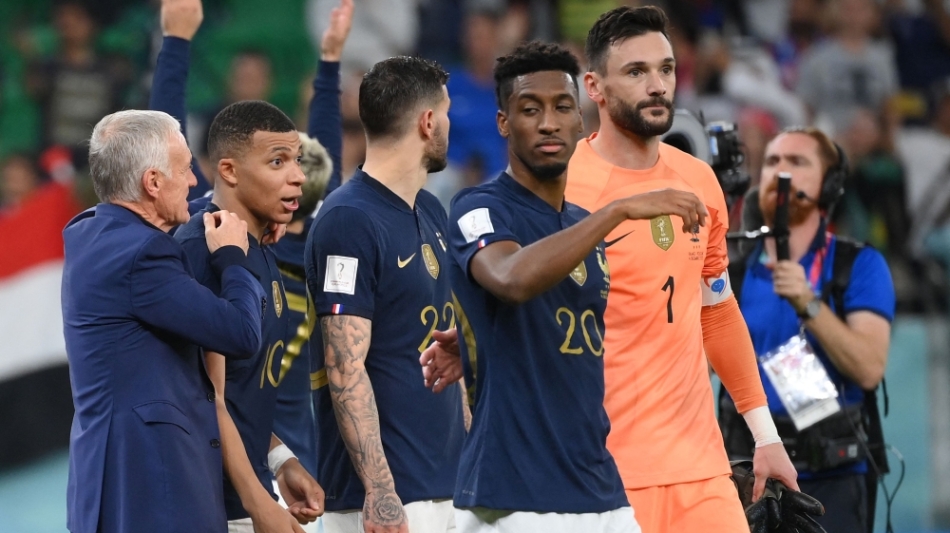 France's coach Didier Deschamps celebrates with Kylian Mbappe after they won the Qatar 2022 World Cup round of 16 match against Poland at the Al-Thumama Stadium in Doha on December 4, 2022. (Photo by FRANCK FIFE / AFP)