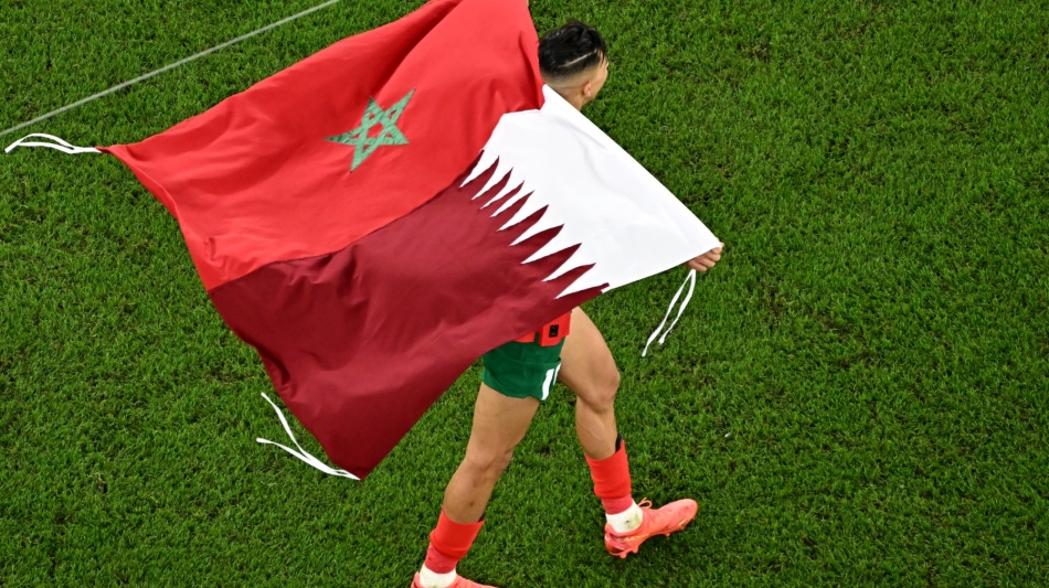 Morocco's defender Jawad El Yamiq celebrates winning the Qatar 2022 World Cup quarter-final match against Portugal at the Al-Thumama Stadium in Doha on December 10, 2022. (Photo by MANAN VATSYAYANA / AFP)
