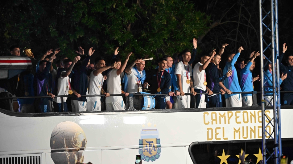 Argentina players celebrate on board a bus as they leave the Ezeiza International Airport: AFP/Luis Robayo