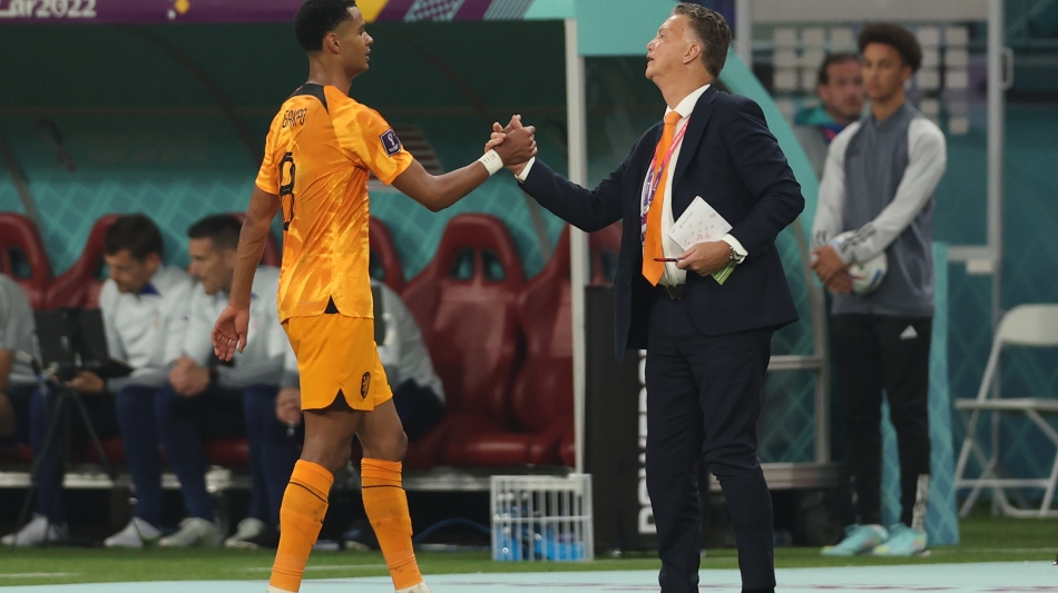 Netherlands coach Louis Van Gaal greets forward Cody Gakpo as he leaves the pitch during their Round of 16 match against USA: AFP/Adrian Dennis