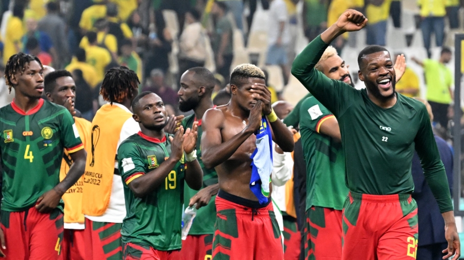 Cameroon's midfielder #22 Olivier Ntcham (right) and teammates celebrate after the Qatar 2022 World Cup Group G match against Brazil at the Lusail Stadium in Lusail on December 2, 2022. (Photo by Issouf SANOGO / AFP)