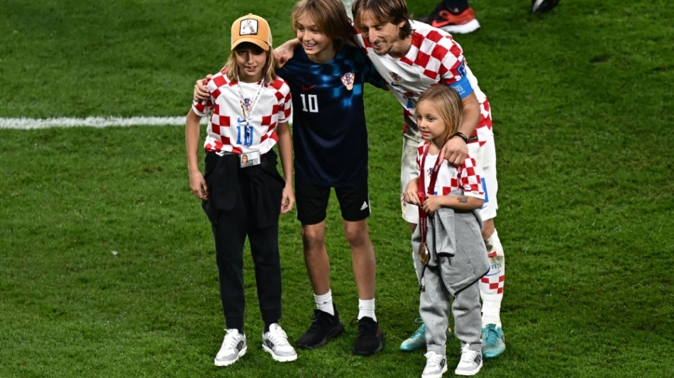 Luka Modric celebrates with his children Ema, Ivano and Sofia after winning the Qatar 2022 World Cup third place play-off match against Morocco at Khalifa International Stadium in Doha on December 17, 2022. (Photo by Anne-Christine POUJOULAT / AFP)