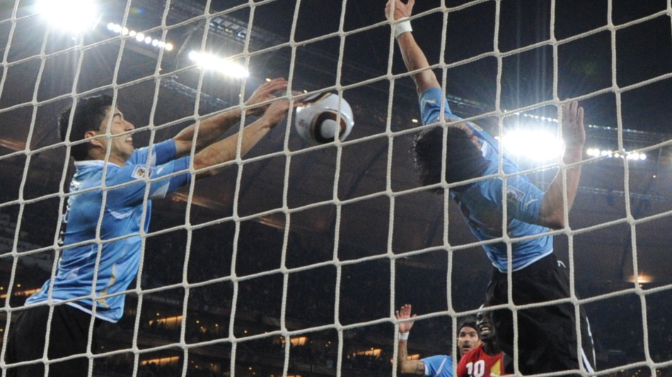 Uruguay’s Luis Suarez, left, stops the ball with his hand leading to a red card and a penalty for Ghana during extra time of their 2010 World Cup quarterfinal: AFP/Roberto Schmidt