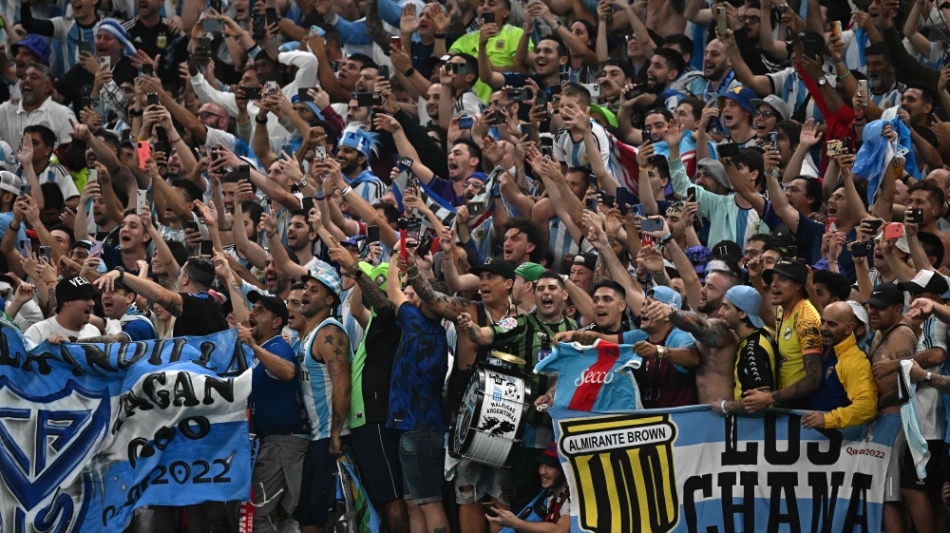 Argentina supporters celebrate after their team won the Qatar 2022 World Cup football semi-final match between Argentina and Croatia at Lusail Stadium in Lusail, north of Doha on December 13, 2022. (Photo by Anne-Christine POUJOULAT / AFP)