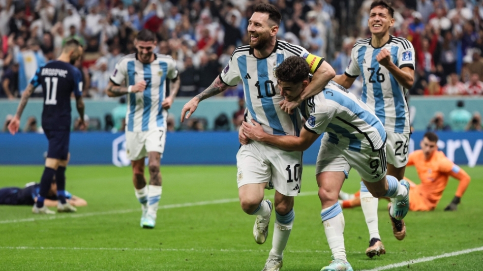 Argentina's Julian Alvarez (centre) celebrates with Lionel Messi after scoring the second goal during the Qatar 2022 World Cup semi-final match against Croatia at Lusail Stadium in Lusail on December 13, 2022. (Photo by JACK GUEZ / AFP)
