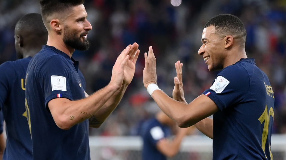 France’s Kylian Mbappe, right, celebrates scoring their second goal with team-mate Olivier Giroud against Poland: AFP/Franck Fife