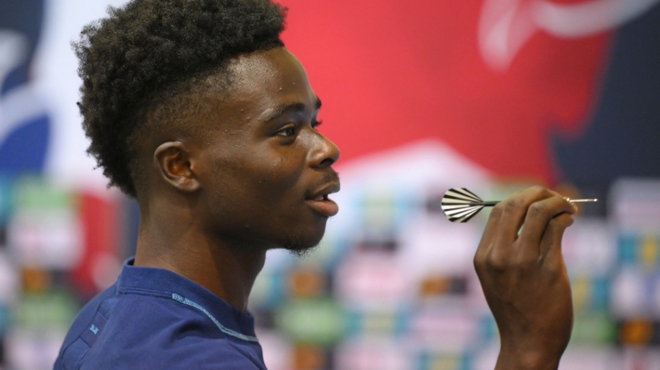 England痴 Bukayo Saka takes part in a darts competition against a journalist at Al Wakrah SC Stadium in Al Wakrah on December 5, 2022 during the Qatar 2022 World Cup football tournament. (Photo by Paul ELLIS / AFP)