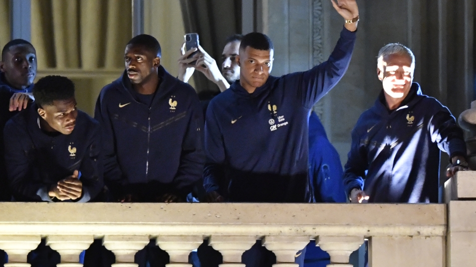 France players and coach Didier Deschamps greet supporters at the Hotel de Crillon, Place de la Concorde, in central Paris: AFP/Julien De Rosa
