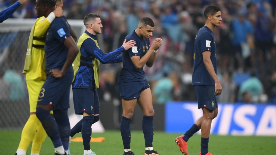 France's Kylian Mbappe and teammates react after losing in the penalty shoot-out of the Qatar 2022 World Cup football final match against Argentina at Lusail Stadium in Lusail on December 18, 2022. (Photo by FRANCK FIFE / AFP)